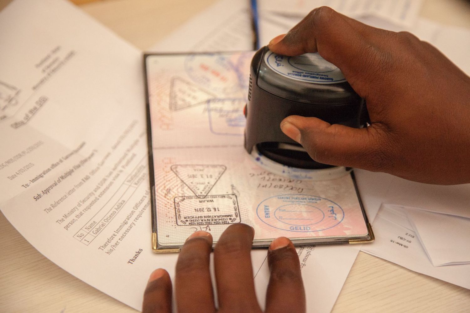 A travel document being stamped in Somalia.