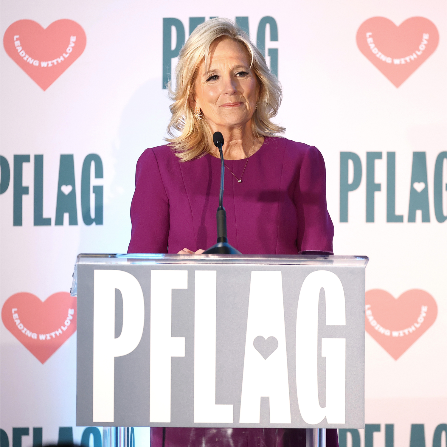 A photo of First Lady Jill Biden, a short woman with blonde hair in a purple suit.