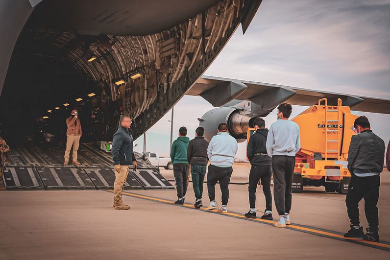 Noncitizens being deported to Ecuador board a military plane in Texas.