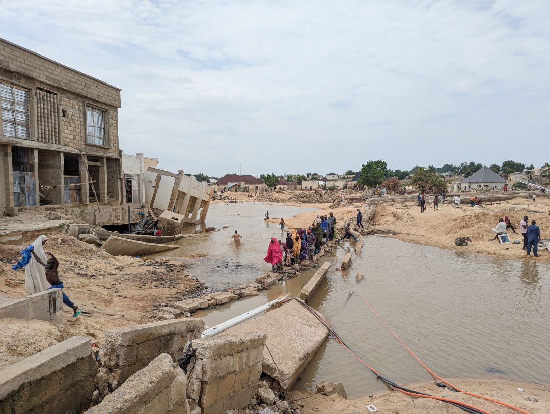People walk through floodwaters in Nigeria.