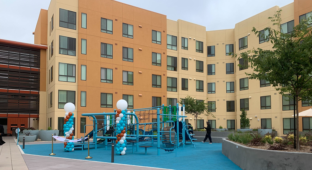 Building with playground in the foreground
