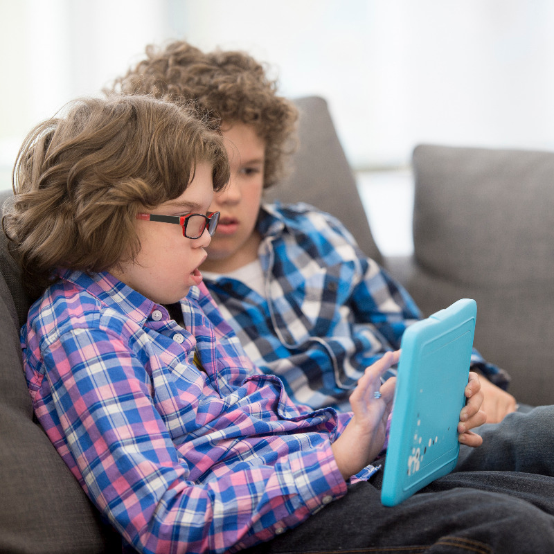 Two children with disabilities using a tablet.