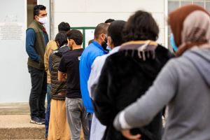 Afghan parolees wait in line at Fort McCoy, Wisconsin.