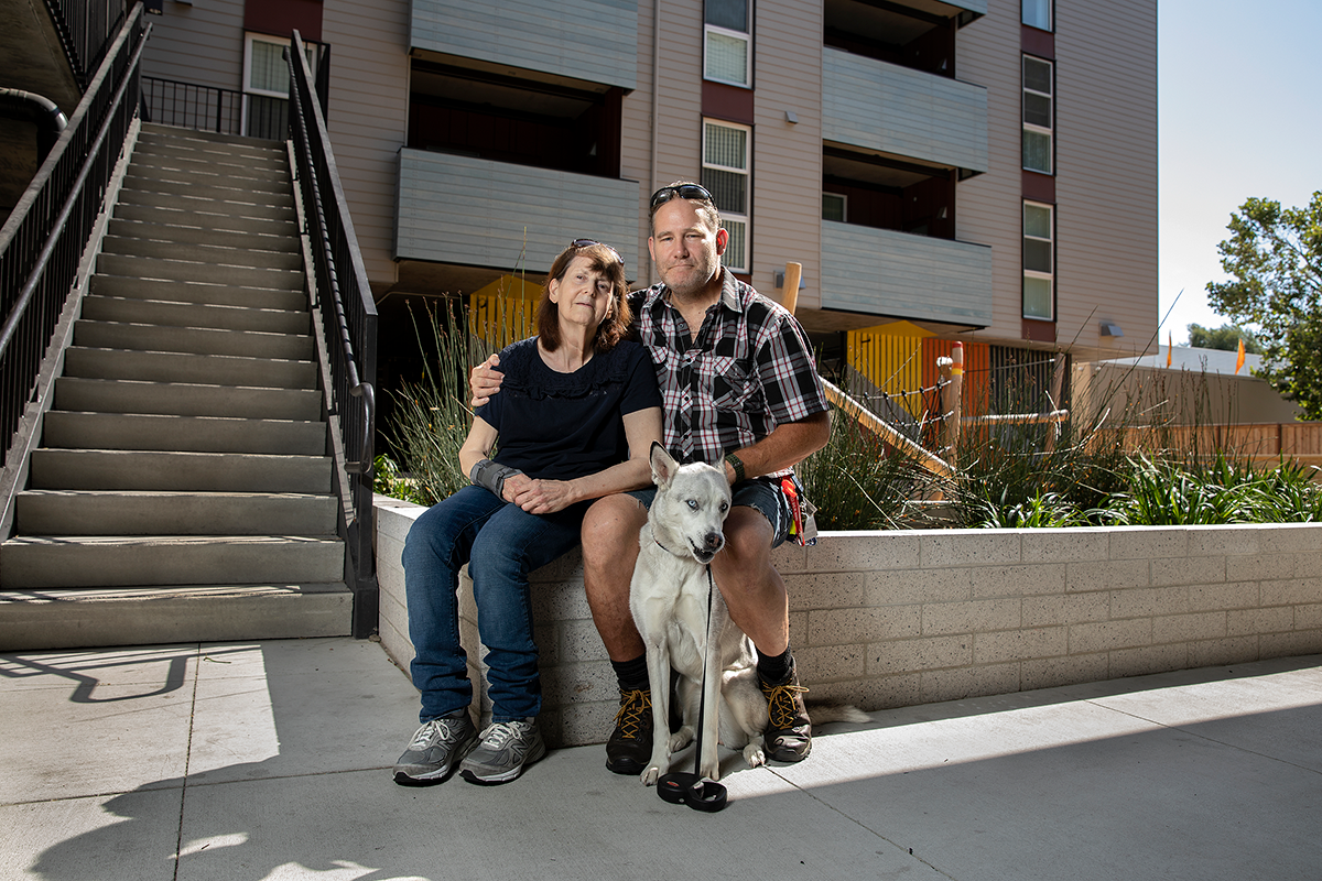 Family sitting on ledge in front of stairwell
