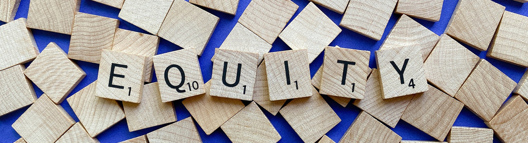 Image of scrabble pieces that spell equitty