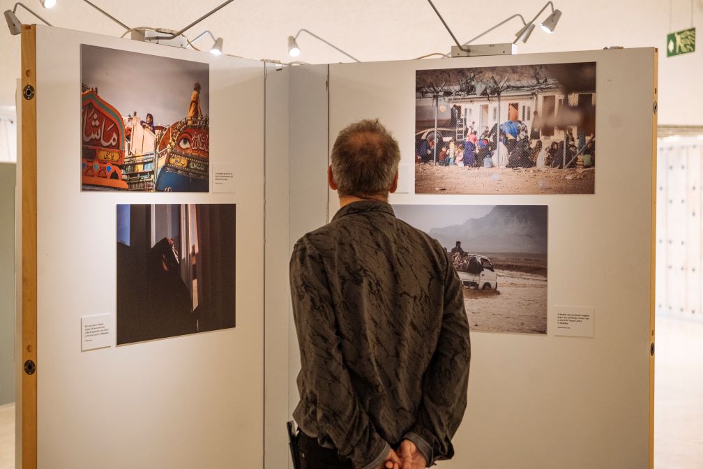 A person views photos in an art exhibition.