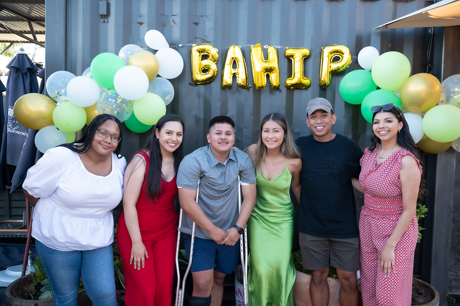 Group of BAHIP interns in front of balloons that say 