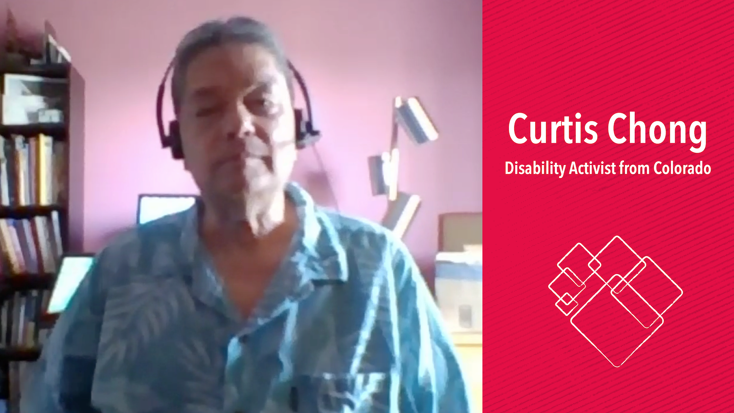 Curtis, an Asian American, looks to the web camera and wears a head set