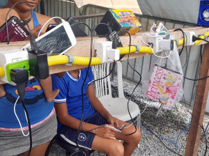 Venezuelan migrants charge their phones and other devices at a power point in Boa Vista, Brazil.