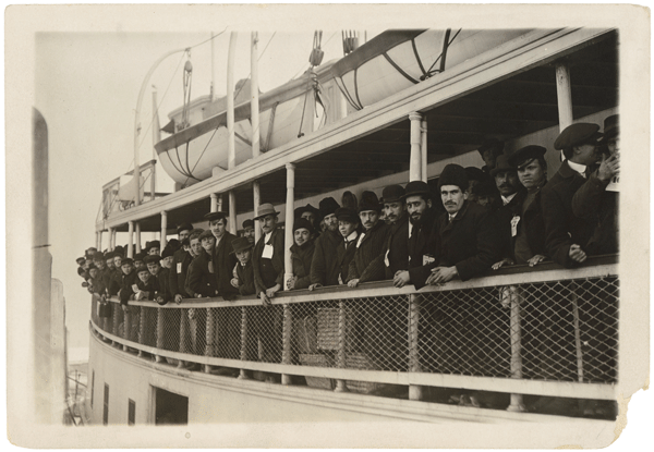 Immigrants arriving on a ferry near Ellis Island.