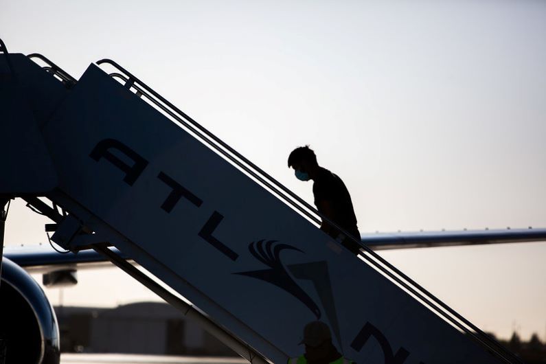 A man boards a repatriation charter flight to Guatemala.
