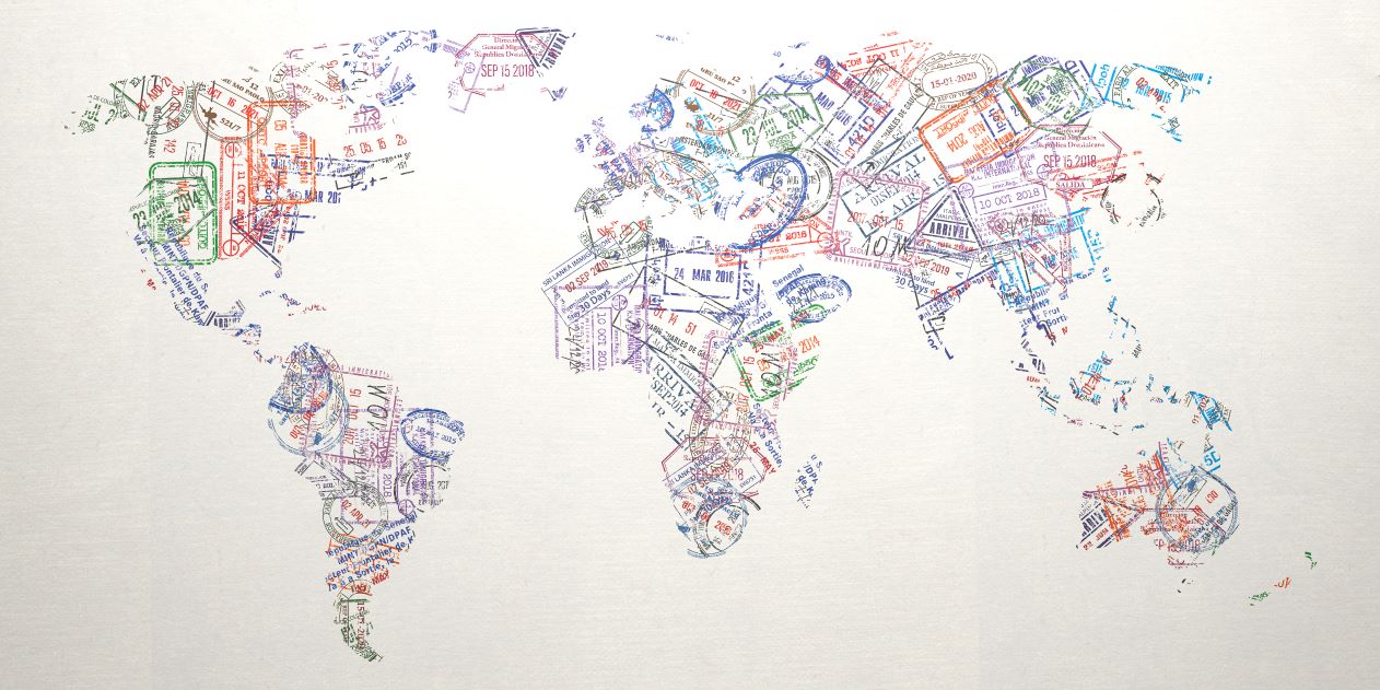 Passport stamps of different countries forming a world map.