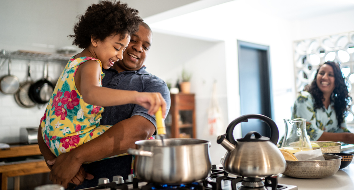 A family cooks together in their kitchen
