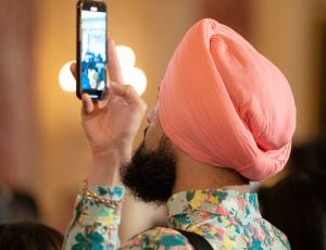 A guest takes a photo at a Diwali reception at the White House.