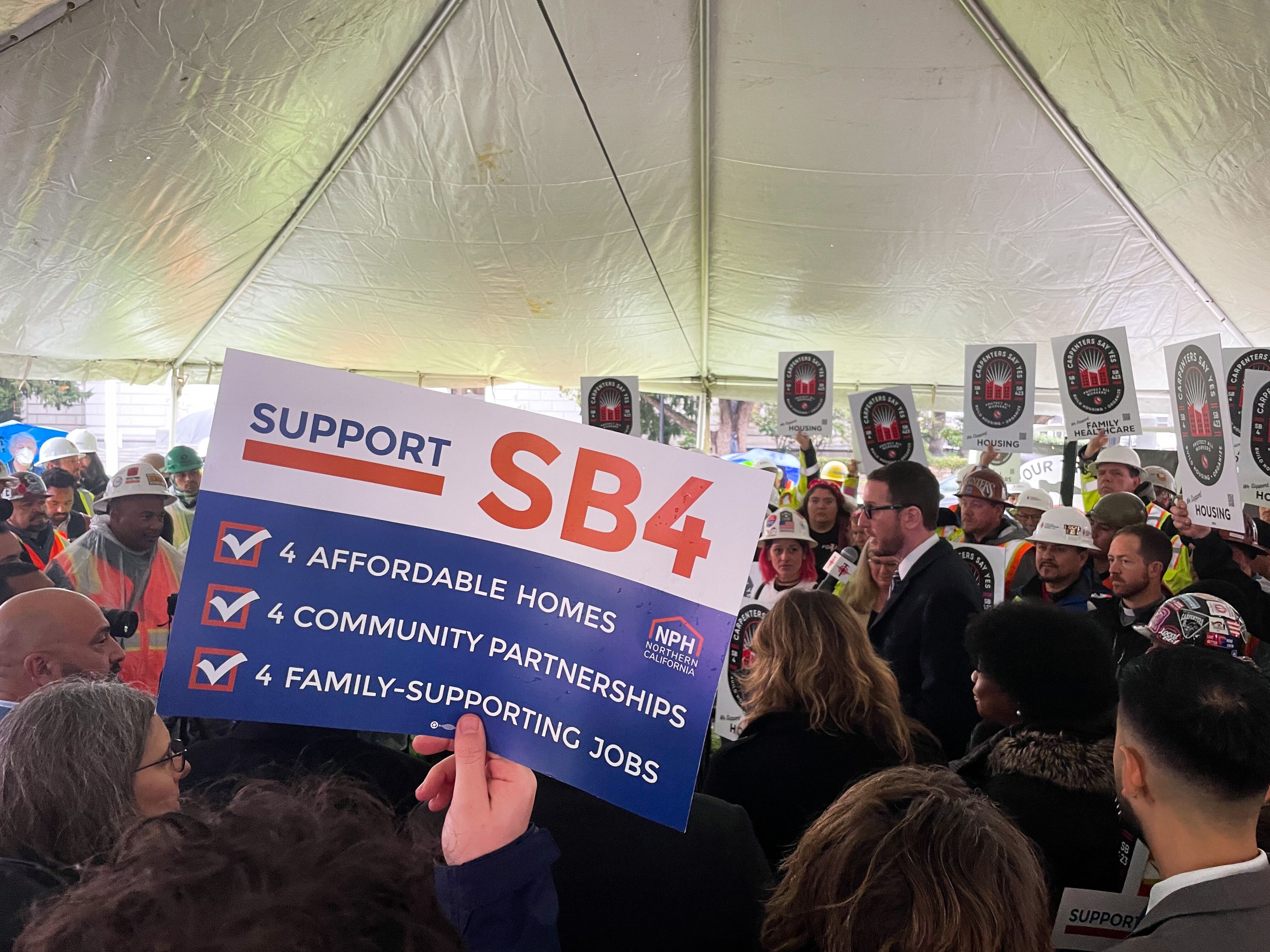 Someone holding a SB 4 sign