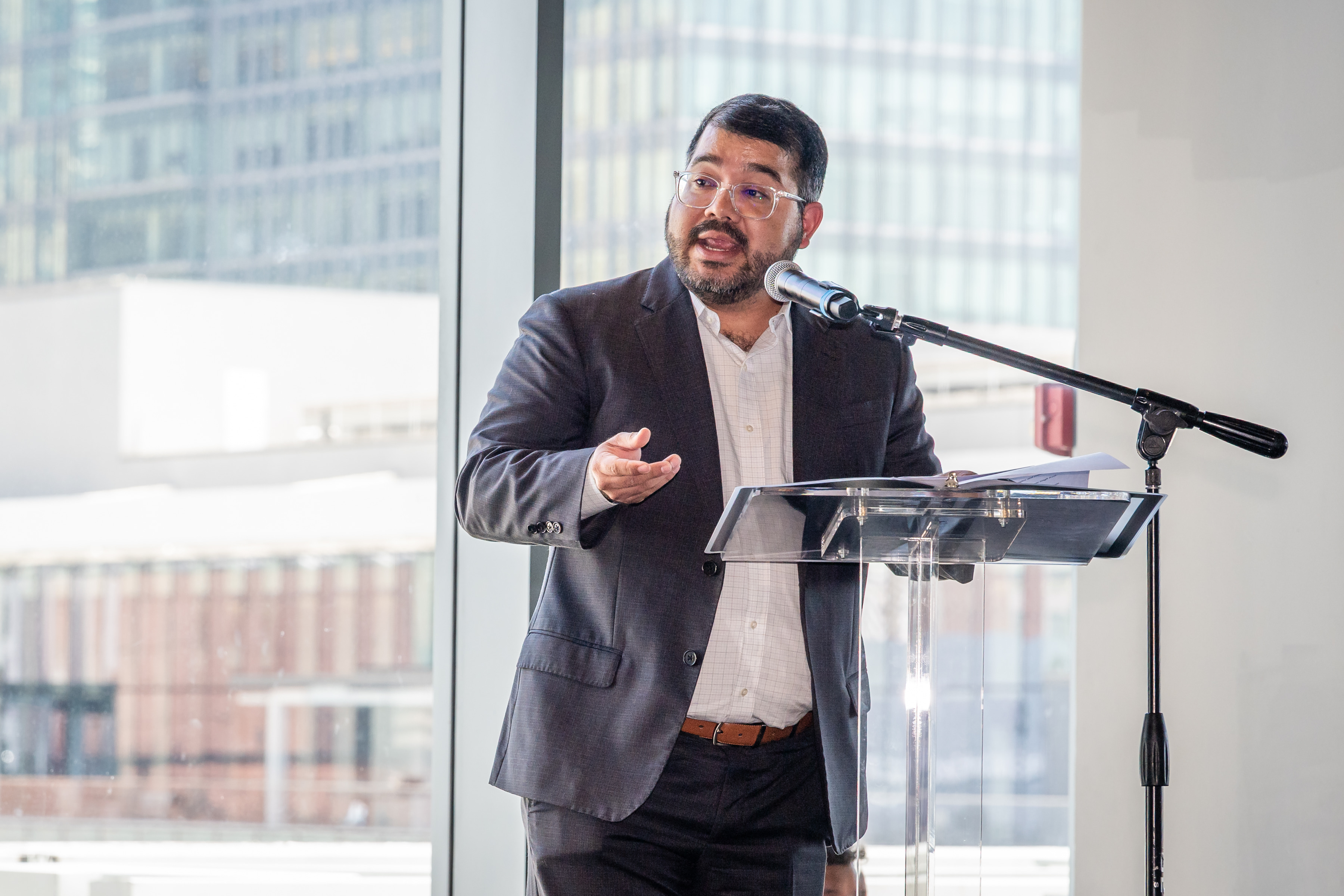 Pedro speaking at a podium