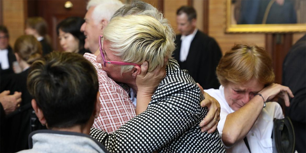 Two women embracing after court ruling to end the LGBT Purge in Canada