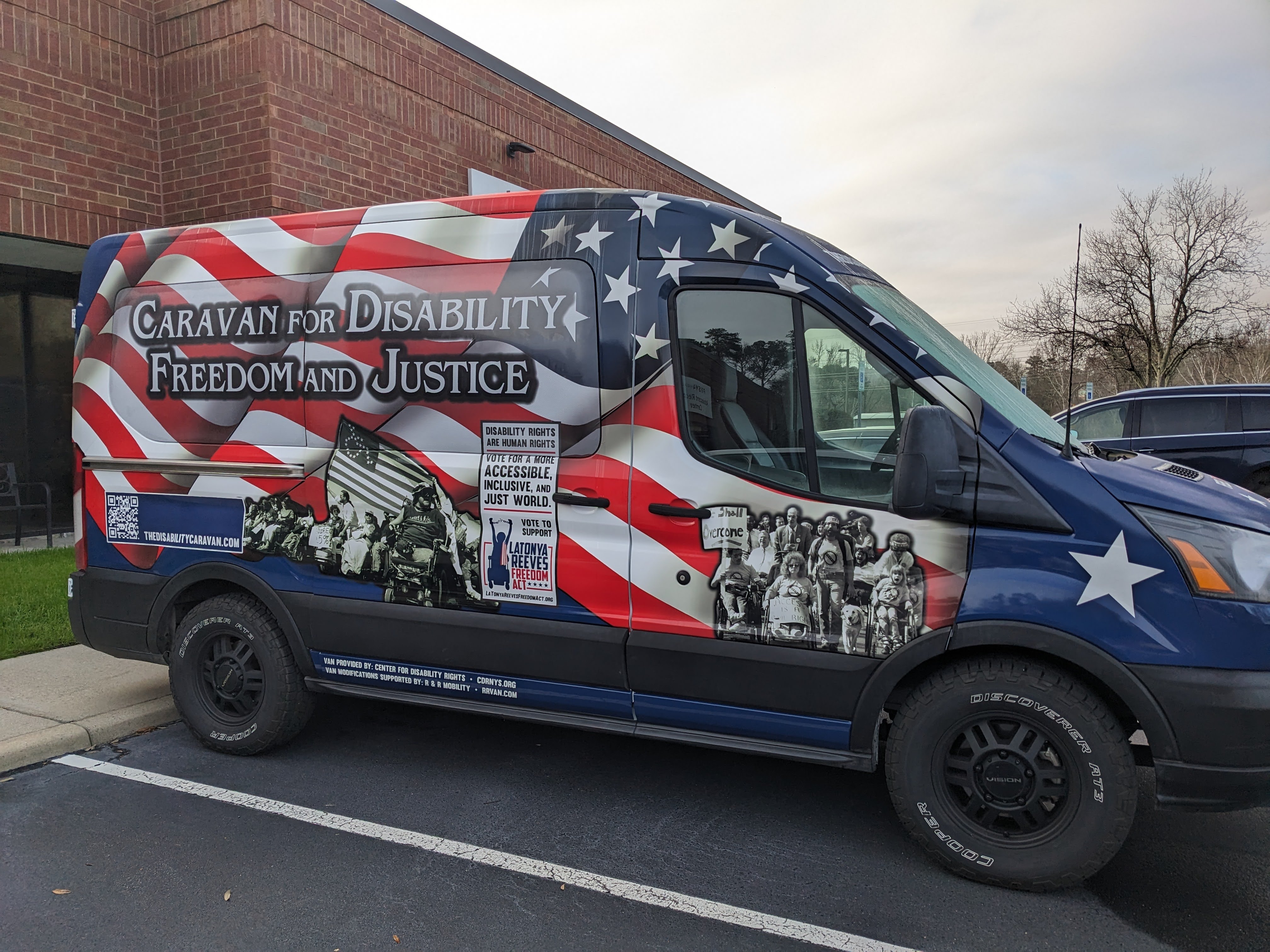 Caravan Van with images of disability rights history and large American Flag.