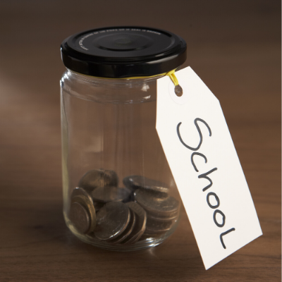 photo of jar full of coins with a label that says school