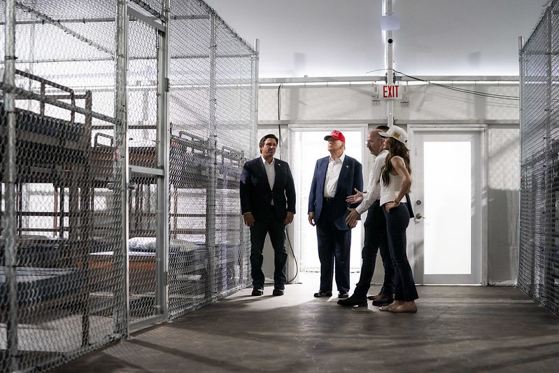President Donald Trump tours Alligator Alcatraz in Florida, alongside Governor Ron DeSantis, Homeland Security Secretary Kristi Noem, and others.