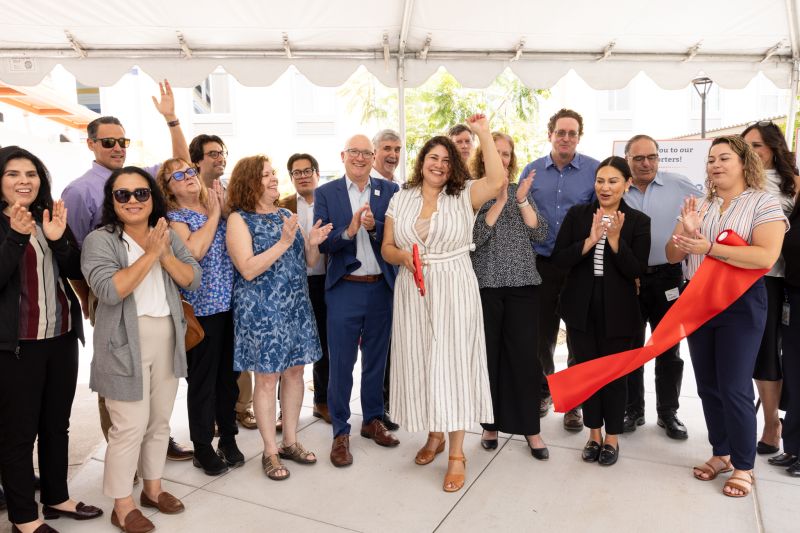 Attendees cutting ribbon