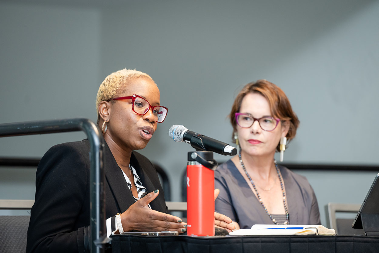 Board President Shola speaking on a panel
