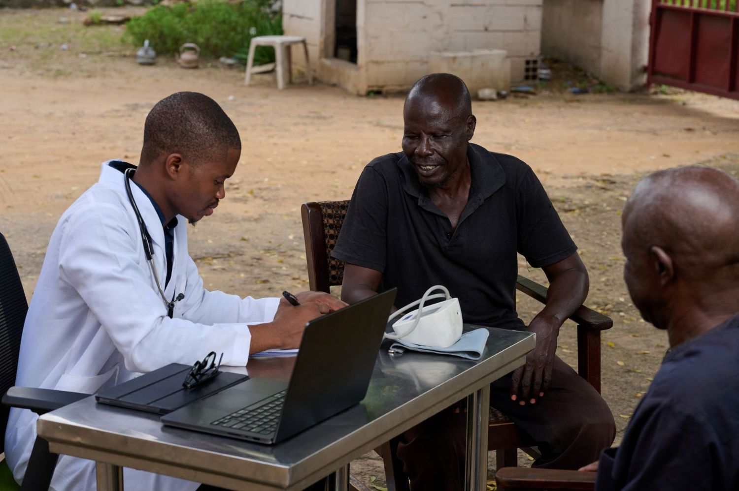 A doctor talks to a patient in Nigeria.