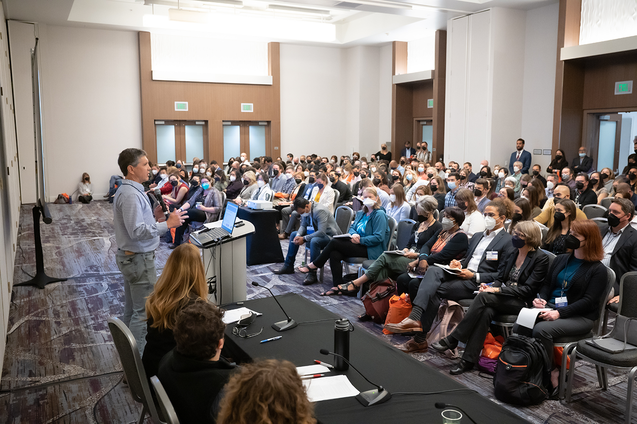 Man speaking to an audience in a room