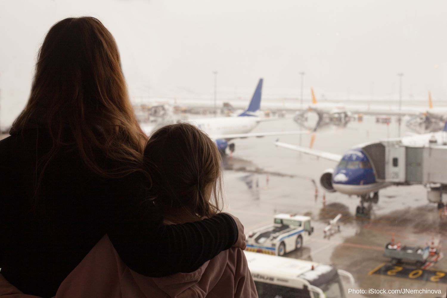 A woman and child watching airplanes