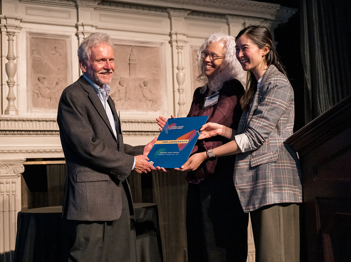 Awardee receiving framed award
