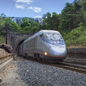 image of an amtrak train exiting a tunnel