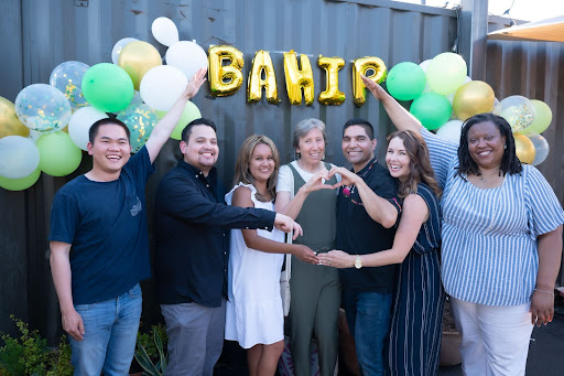 BAHIP mentors and interns posing in front of the sign