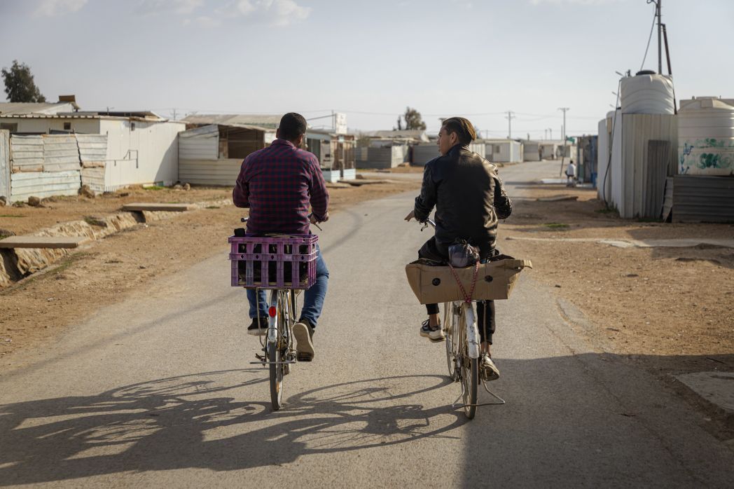 People ride bicycles in the Za'atari refugee camp in Jordan.