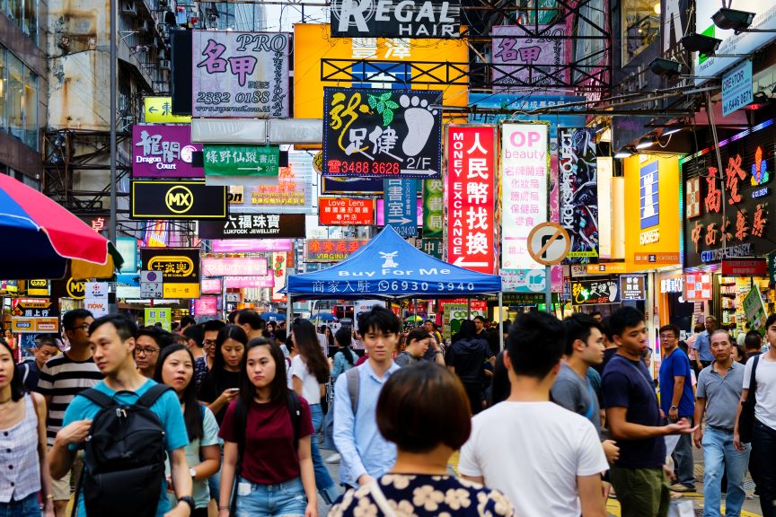 People walk through the streets of Hong Kong.