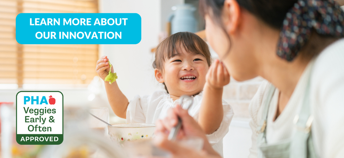 A mom and daughter smile while eating good food. PHA's new Veggies Early & Often icon is in the bottom left corner.Learn more about our innovation!
