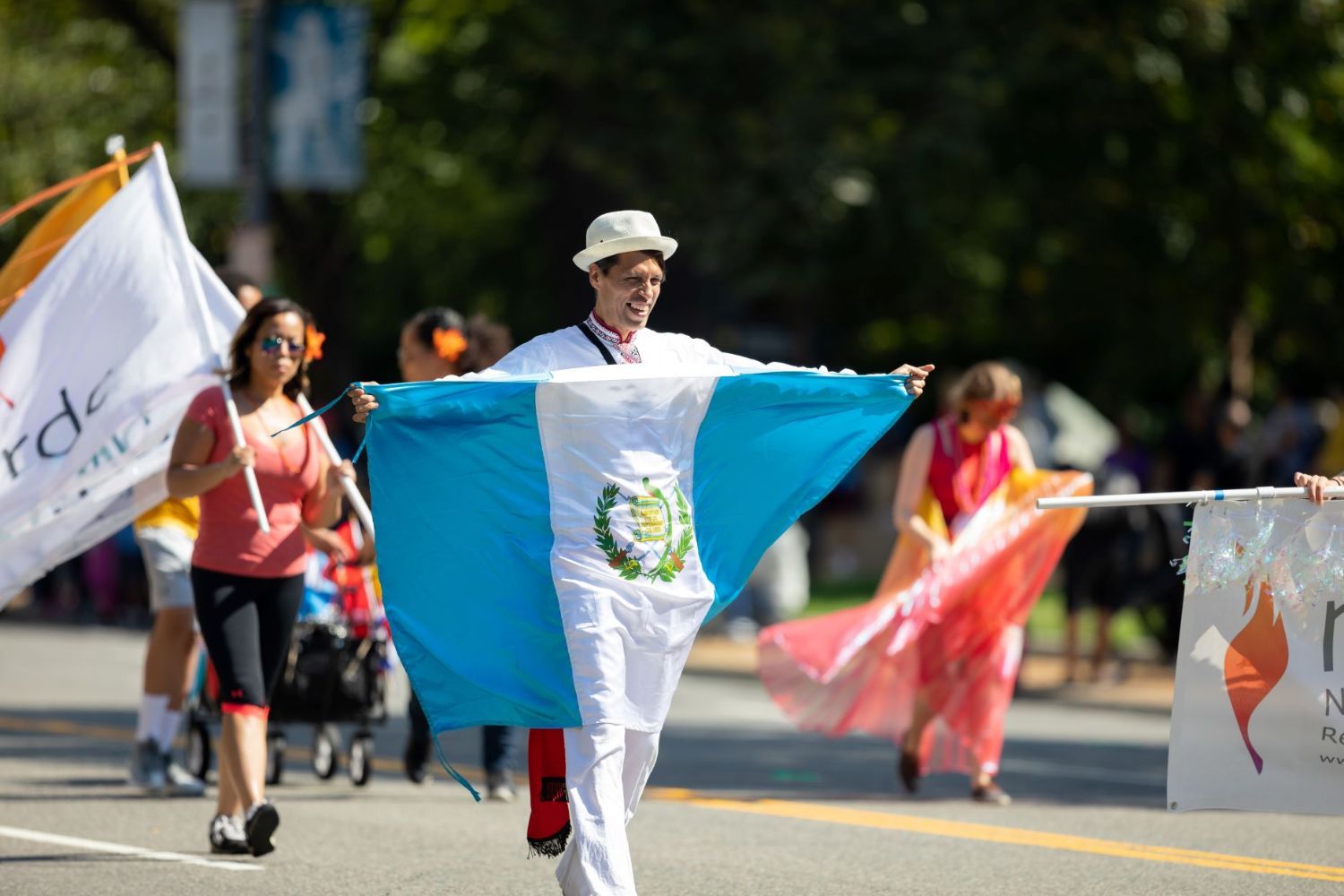 A man carrying the flag of Guatemala in a parade in Washington, DC.