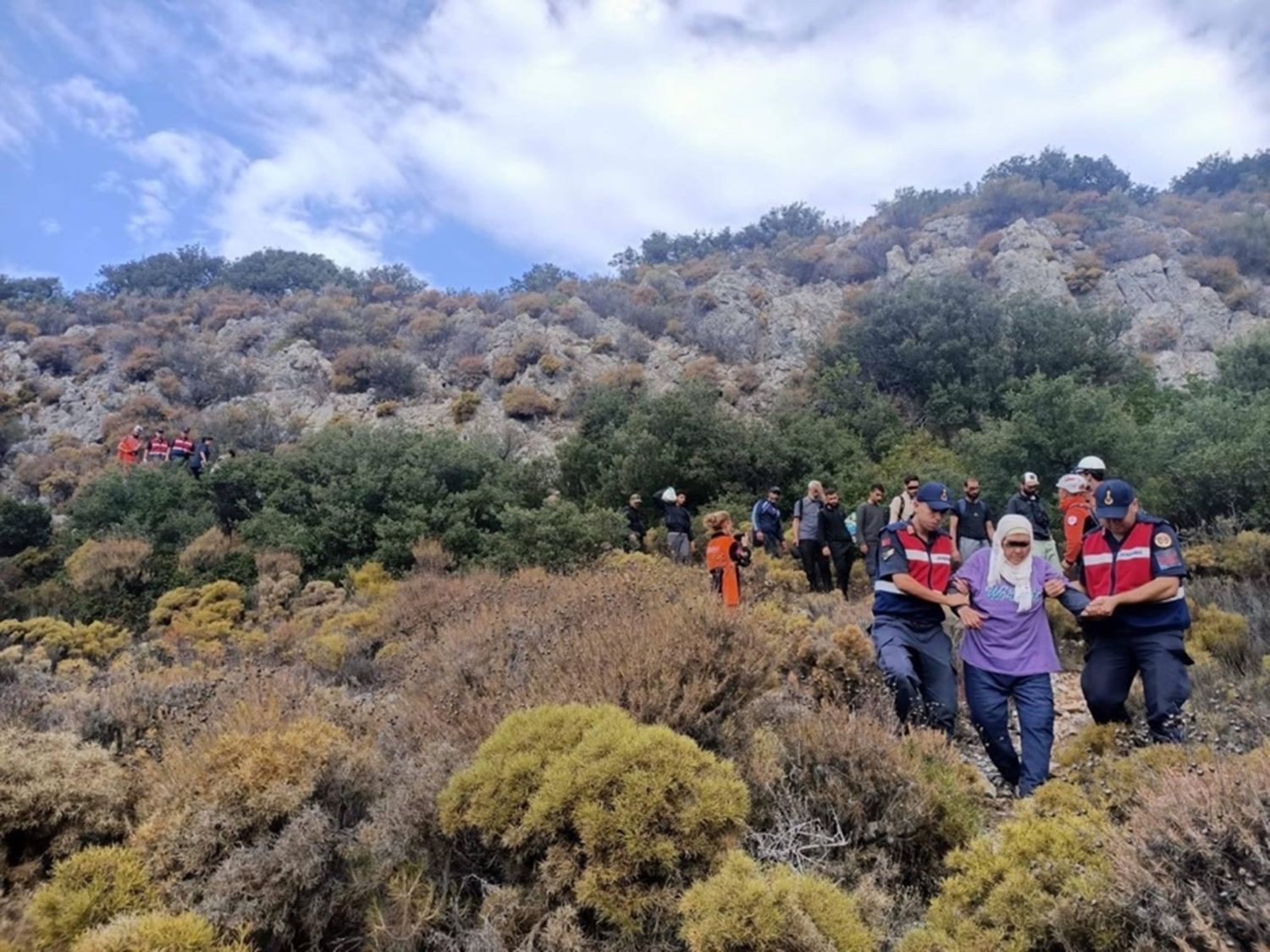 Turkish authorities assist a migrant.