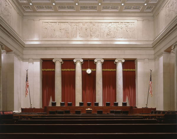 The Supreme Court's hearing room, a large, opulent space with the judges' bench in front of rows of wooden seats.