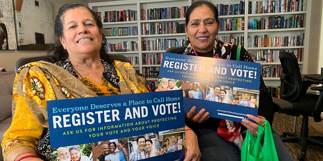 Photo of residents holding voter signs.