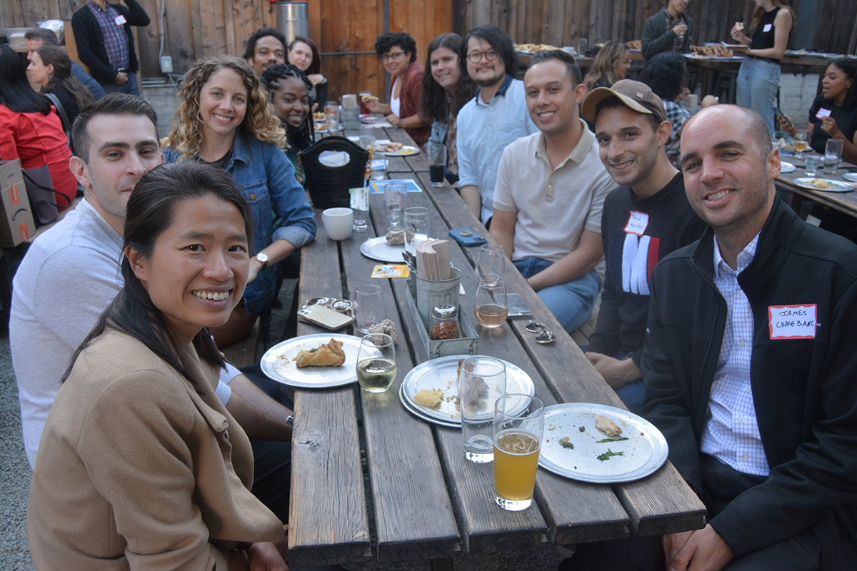 ELPN members sitting at an outside wooden table