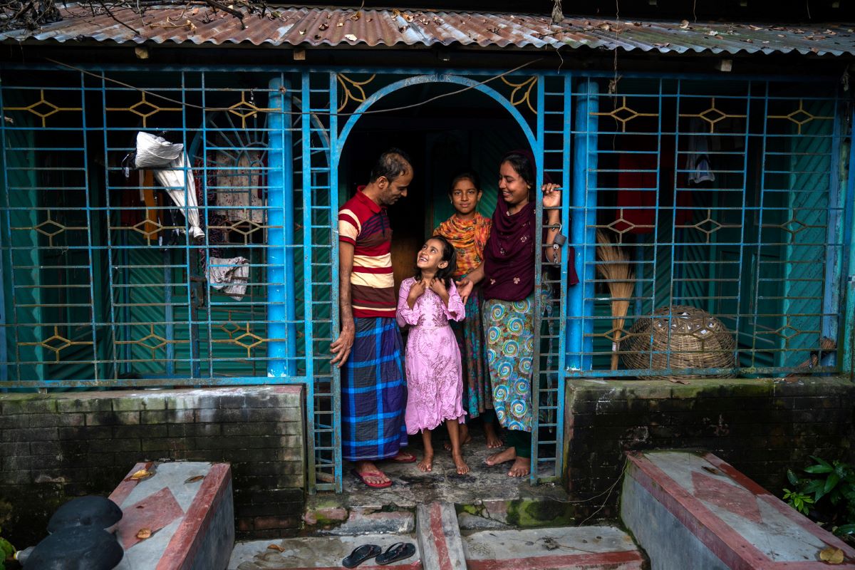 A returned migrant with his family in Bangladesh.