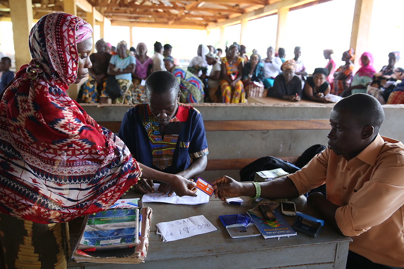 A woman receives a cash transfer in Sierra Leone.