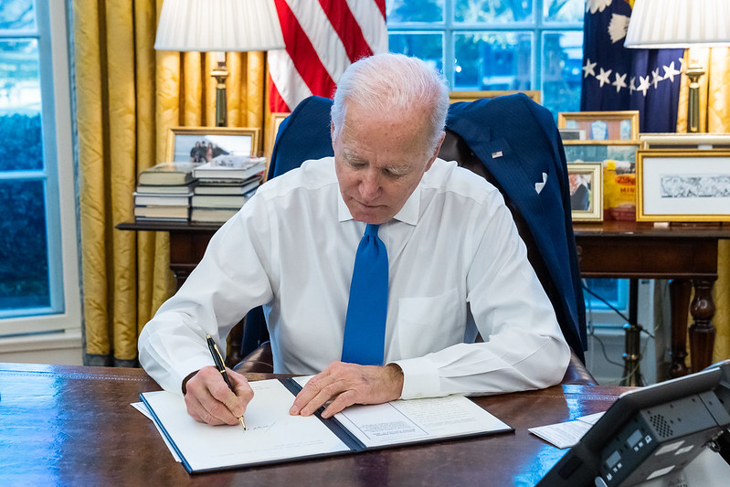 President Joe Biden signs an executive order.