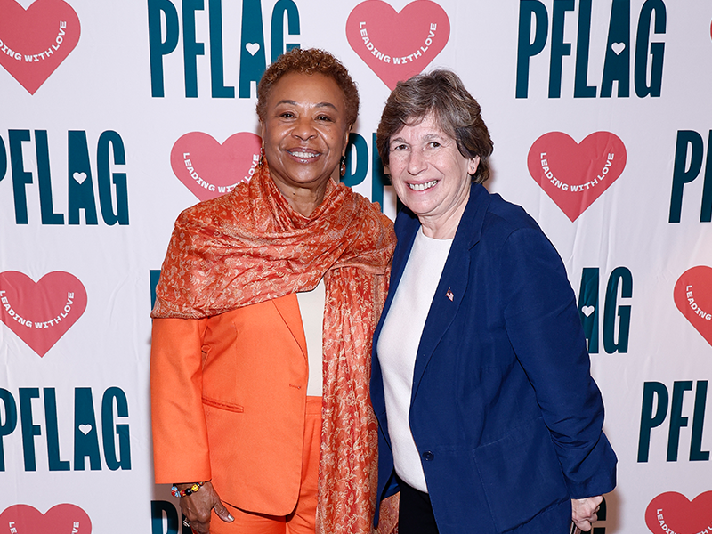 Photo of Congresswoman Barbara Lee and Randi Weingarten in front of a PFLAG backdrop.