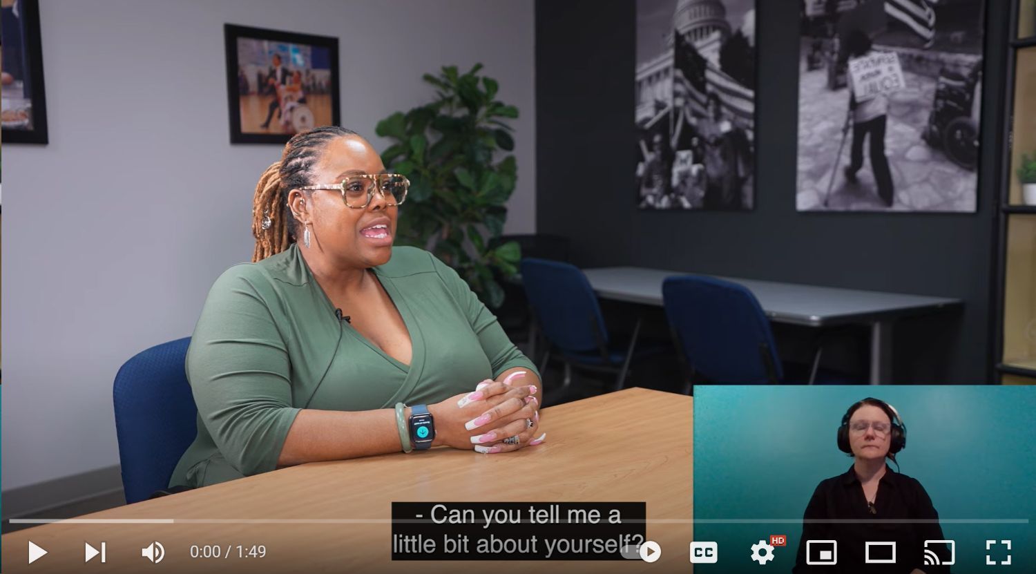 Still shot from the film Accessing Democracy showing Monica Wiley seated at a conference table.